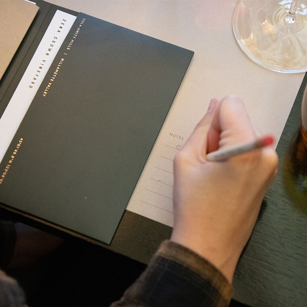 Tasting notes being written on Zena Crown place mat Tasting notes being written on Zena Crown place mat